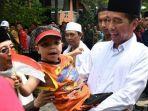 jokowi-gendong-seorang-anak-berkebutuhan-khusus-di-pondok-pesantren-al-ittihad.jpg