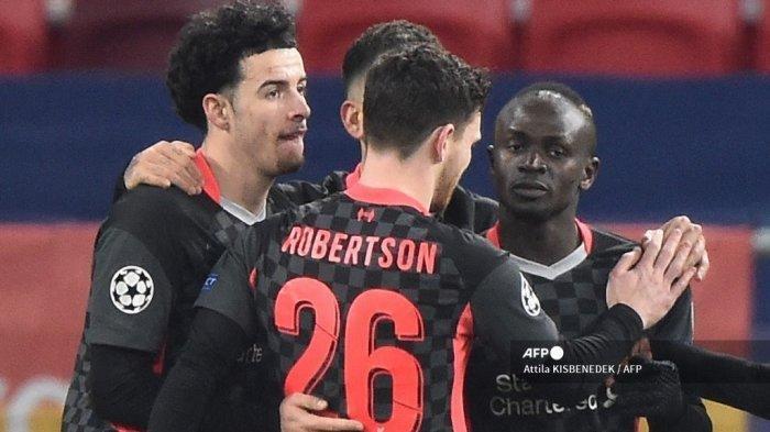 Striker Liverpool Senegal Sadio Mane (kanan) merayakan gol 0-2 bersama rekan satu timnya selama pertandingan sepak bola leg pertama babak 16 besar Liga Champions UEFA antara RB Leipzig dan FC Liverpool di Puskas Arena di Budapest pada 16 Februari 2021.
Attila KISBENEDEK / AFP