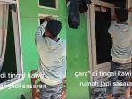 Seorang-pria-berjaket-abu-sedang-memecahkan-jendela-rumahnya-sendiri.jpg