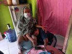 penyintas-husniyah-bersama-anaknya-duduk-di-rumah-kontrakan-sempit-di-praya.jpg