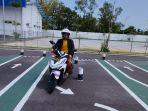 Salah-seorang-pemohon-SIM-baru-saat-ujian-praktik-melewati-perlintasan-jalan-lurus-dan-angka.jpg