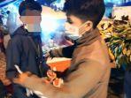 salah-satu-terduga-pelaku-preman-saat-diamankan-di-pasar-malam-bua-toraja-utara.jpg