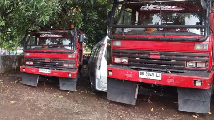 MAFIA SOLAR - Satu mobil tronton berwarna merah ditahan Polda Sulut karena diduga terlibat mafia solar. Truk tronton tersebut diduga milik seorang ASN di Bitung.