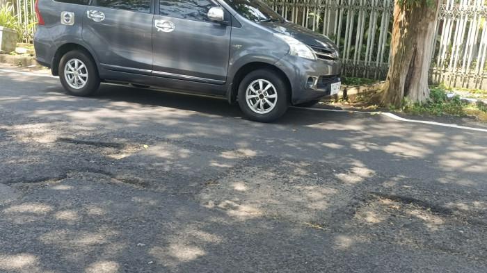 sekira 7 lubang besar dan kecil di jalan seputaran pertigaan menuju Lapangan Sparta Tikala