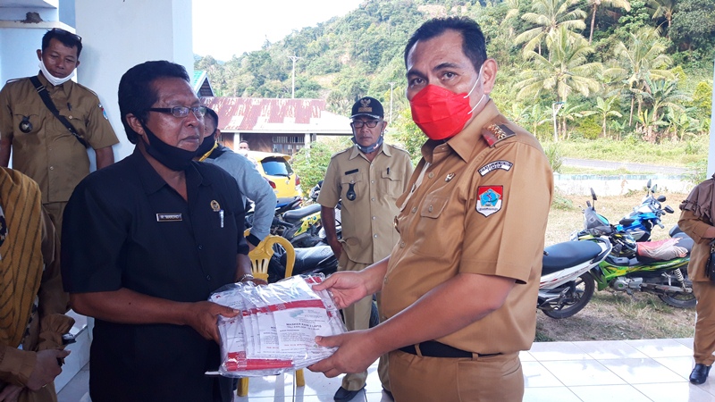 pjs-bupati-boltim-christiano-talumepa-saat-menyerahkan-masker-di-kecamatan-nuangan.jpg