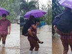 anggota-dprd-bitung-habriyanto-achmad-gedong-sang-istri-lewat-banjir-di-depan-rumah.jpg