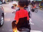 dua-anak-mengendarai-sepeda-motor-yamaha-vega-r-berplat-merah.jpg