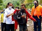 jokowi-beri-jaket-merahnya-kepada-fransiskus-warga-korban-banjir-bandang-di-ntt.jpg