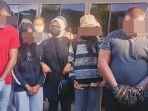 para-tersangka-merunduk-usai-tiba-di-bandara-sam-ratulangi-manadofhfghfghfgh.jpg