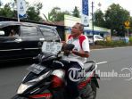 seorang-pria-mengendarai-motor-di-jalan-aa-maramis-manado_20180424_144700.jpg