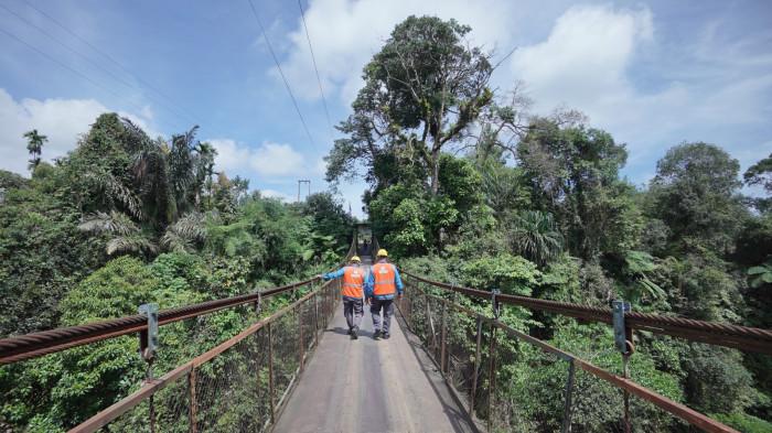 Petugas yantek menyusuri Jembatan Gantung untuk memastikan jaringan