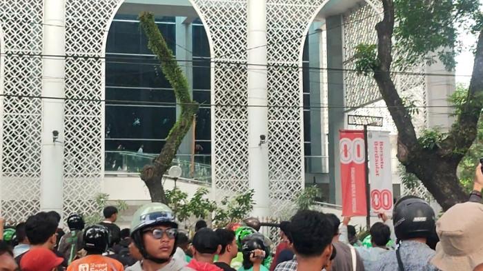 Sejumlah petugas DPRD Sumut saat menyaksikan aksi unjuk  rasa dari atas Ruangan Paripurna, Jumat (29/8/2025).  Namun mereka berhamburan saat para massa melempar batu ke arah gedung.