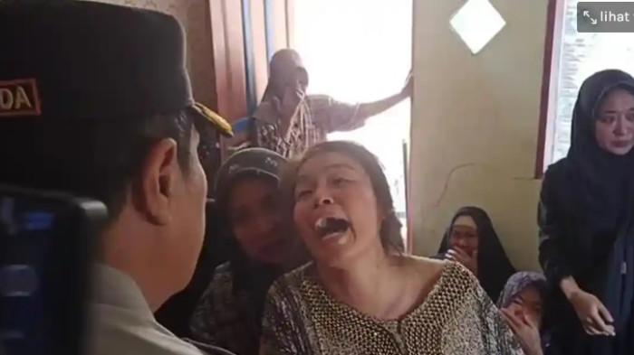 TANGIS HISTERIS – Ibu Bripda DP menggenggam erat tangan Kapolda Sulsel Irjen Pol Djuhandhani Rahardjo Puro sambil menangis histeris saat melayat di rumah duka di Desa Pincara, Kecamatan Patampanua, Kabupaten Pinrang, Senin (23/2/2026). Ia meminta Kapolda mengusut tuntas dugaan penganiayaan terhadap putranya.
