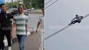 PRIA-BERGELANTUNGAN-Seorang-pria-belum-diketahui-identitasnya-bergelantungan-di-kabel.jpg