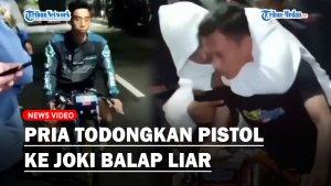 Seorang-pria-menodongkan-pistol-ke-arah-joki-balap-liar.jpg