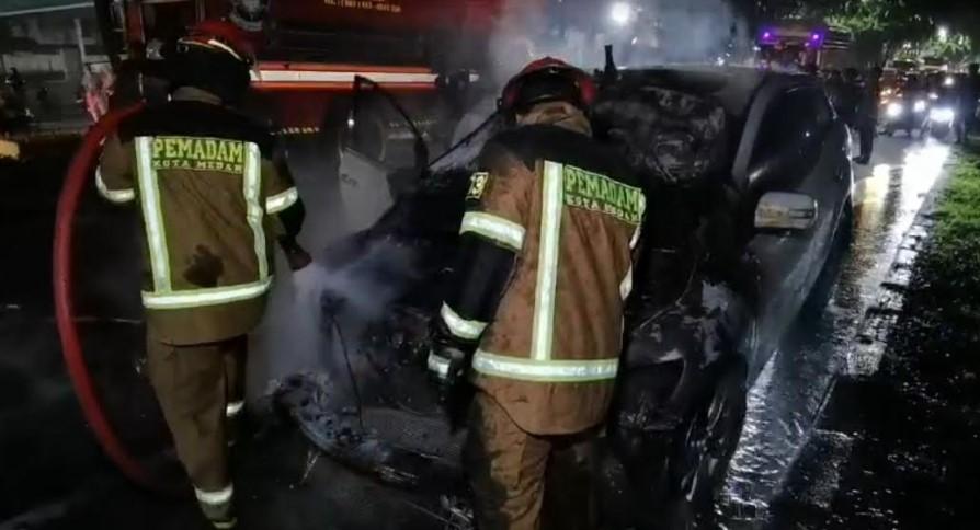 Petugas-pemadam-kebakaran-tampak-melakukan-penyiraman-ke-arah-mobil-yang-terbakar.jpg