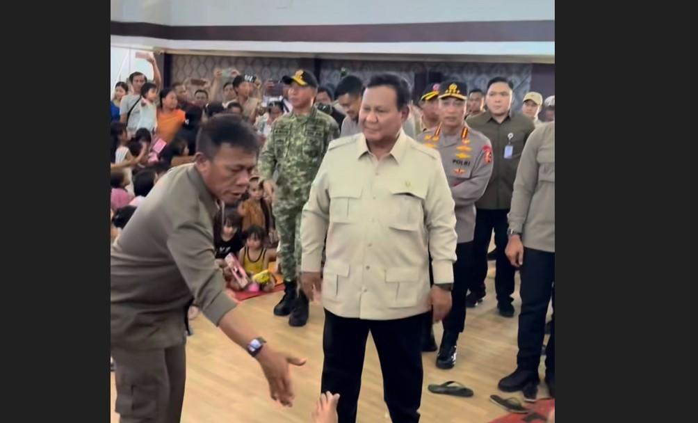 Presiden Prabowo Subianto memimpin rapat koordinasi penanganan dampak banjir bandang dan longsor di Posko Terpadu Lanud Sultan Iskandar Muda, Kabupaten Aceh Besar. Terlihat beliau berbicara serius dengan jajaran pejabat BNPB dan terkait, membahas bantuan perbaikan hunian bagi pengungsi. Suasana rapat menunjukkan keseriusan dalam penanggulangan bencana.