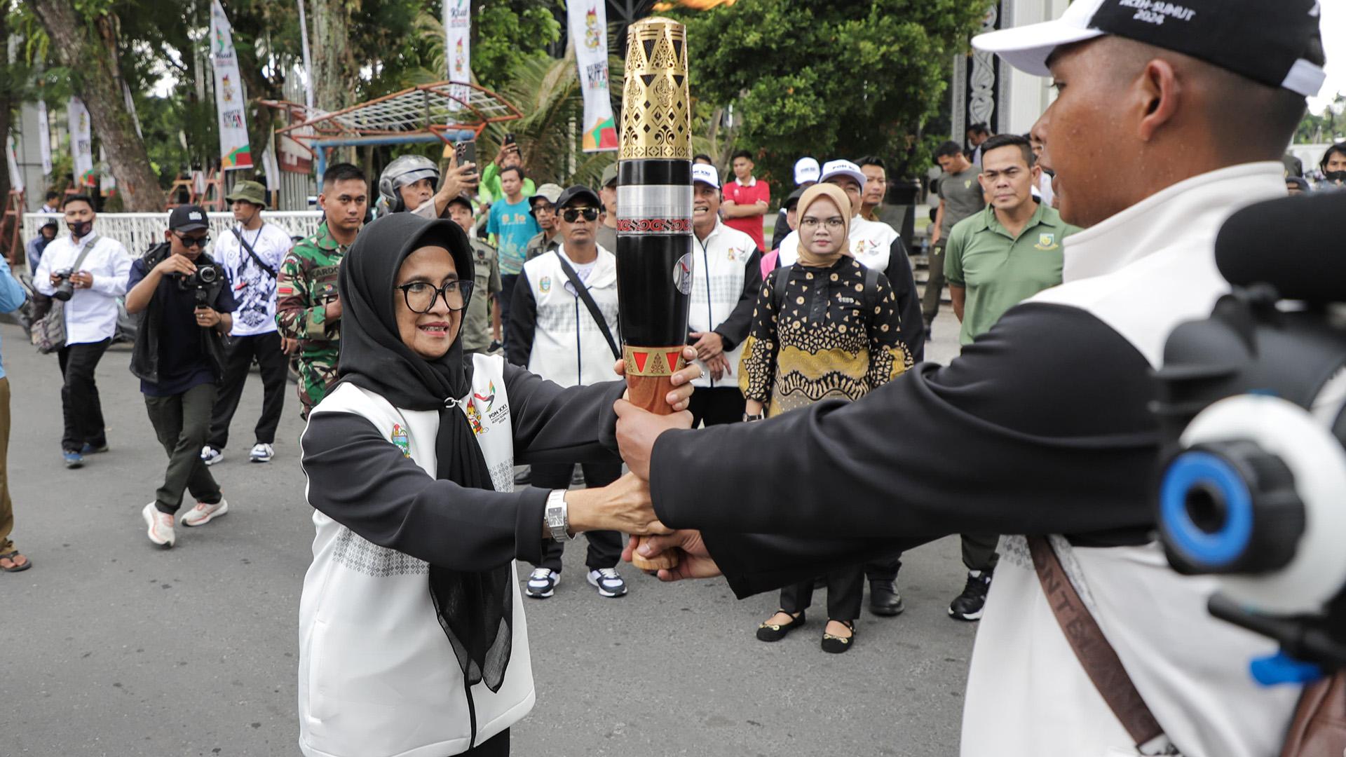 Wali-Kota-Susanti-menerima-api-obor-PON-yang-dibawa-Tim-Kirab-PON-XXI-saat-melintasi-Siantar-1.jpg