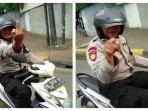 Oknum-polisi-tampak-mengacungkan-jari-tengah-ke-arah-relawan.jpg