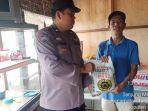 Polsek-Tanjungmorawa-bagikan-bansos-ke-warga-triibun.jpg