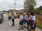 melayani-rombongan-anak-SMP-menyeberang-jalan-pada.jpg