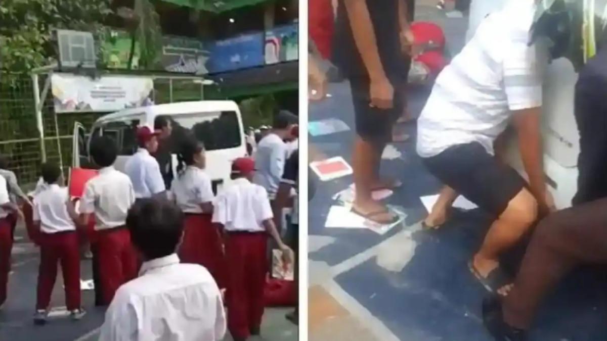 MOBIL TUBRUK SISWA - Warga dan guru berupaya mengevakuasi siswa SDN Kalibaru yang tertuburk mobil MBG.