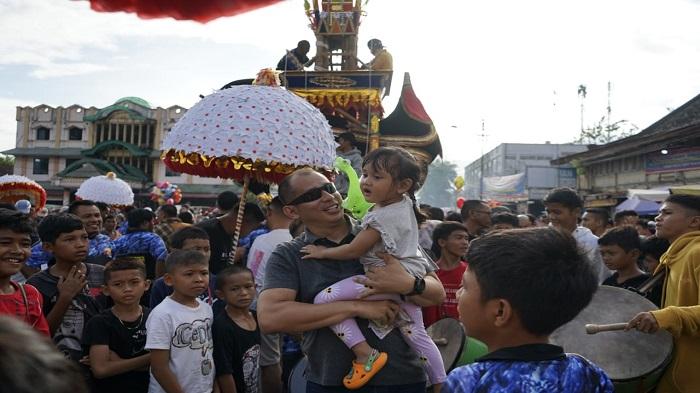 pengunjung-gendong-anak-di-gelaran-budaya-hoyak-tabuik-pariaman.jpg