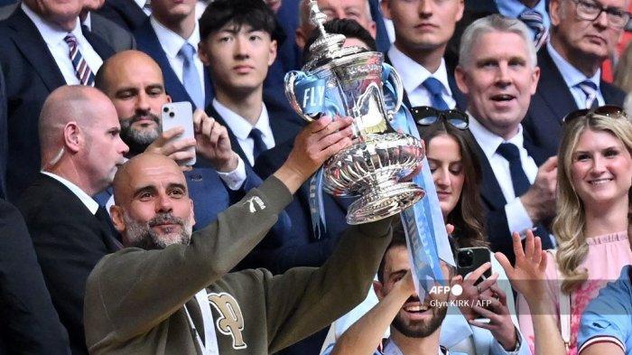 Manajer-Manchester-City-Pep-Guardiola-mengangkat-trofi-Piala-FA.jpg