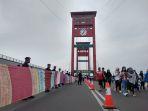 kain-jumputan-terpanjang-di-dunia-membentang-sepanjang-jembatan-ampera-palembang.jpg