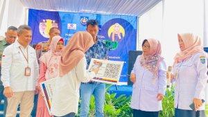 Bupati-Tegal-Umi-Azizah-kerudung-motif-kembang-simbolis-menyerahkan-kartu-E-retribu.jpg