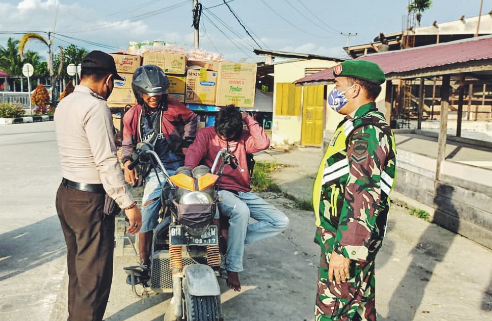 petugas-memberhentikan-pengendara-tak-pakai-masker-di-tembilahan.jpg