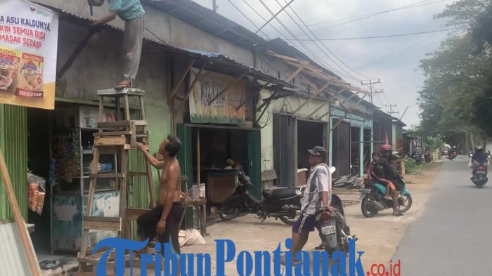TERTIBKAN BANGUNAN - Sejumlah warga atau pemilik bangunan tampak sedang merapikan bagian depan bangunan agar tidak menjulang ke badan Jalan KH. Abdurahman Wahid, Desa Kuala Dua, tepatnya di Simpang WBA, Kecamatan Sungai Raya, Kabupaten Kubu Raya, Selasa 10 Februari 2026.