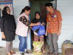 Salah-seorang-Srikandi-PLN-UID-Kalbar-menyalurkan-paket-sembako-untuk-warga-kurang-mampu.jpg