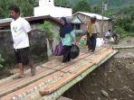Warga-melintas-di-jembatan-darurat-dari-batang-pohon-kelapa-di-Desa-Tallambalao.jpg