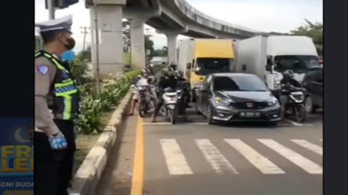 KEMACETAN - Personil Satlantas Poltabes Palembang melakukan rekayasa lalu lintas terkait kemacetan yang terjadi di simpang Bandara Internasional Sultan Mahmud Badaruddin (SMB) II Palembang menuju ke arah Tanjung Api-Api (TAA).
