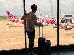 ilustrasi-wisatawan-naik-maskapai-air-asia.jpg