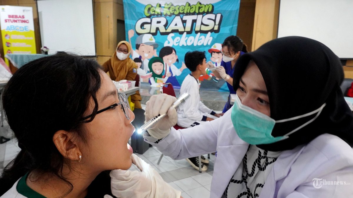 CEK KESEHATAN GRATIS - Sejumlah murid mengikuti cek kesehatan saat pelaksanaan program Cek Kesehatan Gratis (CKG) Untuk Anak Sekolah Menengah Pertama di SMPN 5 Kota Bandung, Jawa Barat, Senin (4/8/2025). Pemerintah resmi memulai program CKG di sekolah-sekolah secara serentak pada 4 Agustus 2025. Kementerian Kesehatan mengungkapkan sebanyak 53 juta pelajar bakal mendapatkan fasilitas pemeriksaan kesehatan gratis. Mereka merupakan pelajar sekolah dan madrasah yang berjumlah 230 ribu unit di seluruh Indonesia. (TRIBUN JABAR/GANI KURNIAWAN)