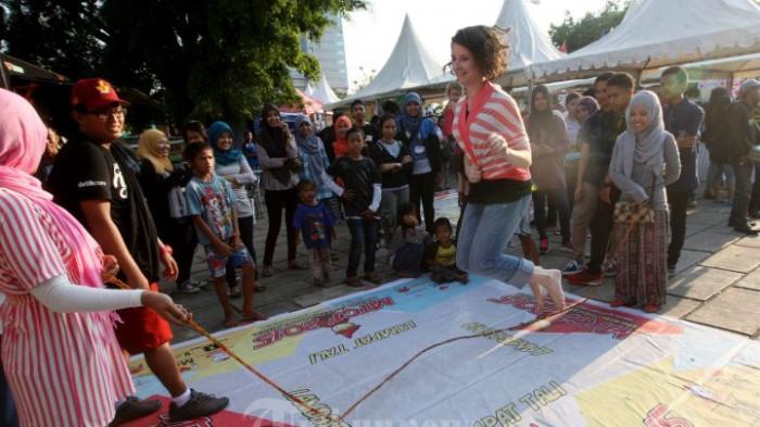 LOMPAT TALI - Wisatawan asal Amerika, Danielle bermain lompat tali pada kegiatan Makassar Tradisional Games Festival (MTGF) 2015 di Benteng Rotterdam, Makassar, Sulsel, Sabtu (17/10).