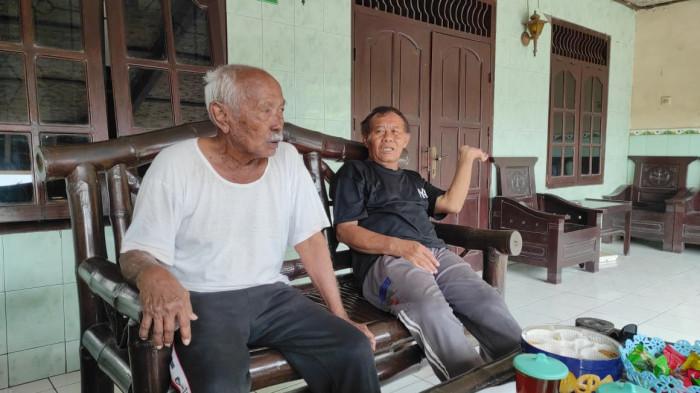 BERANGKAT HAJI - Mbah Dalimin (kiri) bersama anaknya, Widodo (kanan) saat ditemui Tribunnews di rumahnya, Karangdowo Klaten, Jumat (17/4/2026).