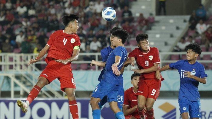 Pesepak bola Timnas Indonesia, Putu Panji (kiri) menyundul bola pada pertandingan Timnas Indonesia vs Singapura ASEAN U16 Boys Championship 2024 di Stadion Manahan, Solo, Jumat (21/6/2024) malam. TRIBUNNEWS/Muhammad Nursina