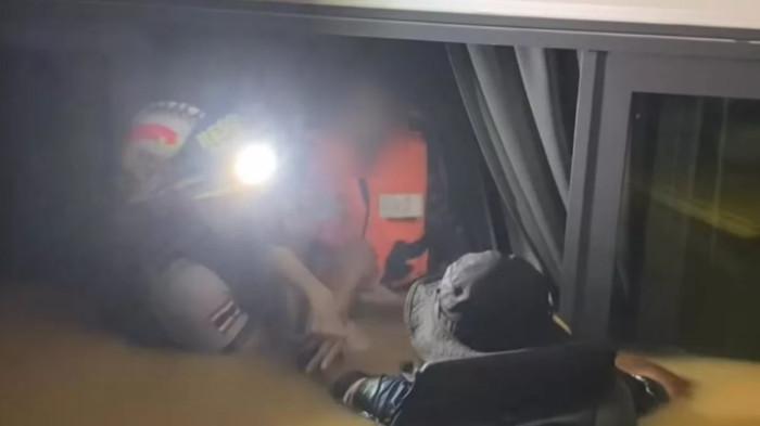 Tim SAR menyelamatkan seorang warga dari rumahnya yang terendam banjir di Hat Yai, bersama kulkas terapung berisi jenazah ibunya yang tenggelam. (Foto: Letnan Muda Wallop Boonchan)