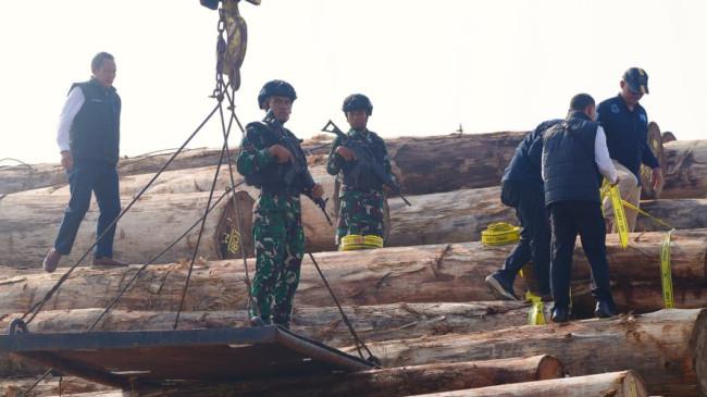 Saat Prajurit TNI Bersenjata Lengkap Berjaga di Atas Ribuan Kubik Kayu Ilegal Sitaan Satgas PKH