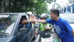 Seorang-kader-Partai-Demokrat-membagikan-nasi-kotak-HUT-Partai-Demokrat.jpg