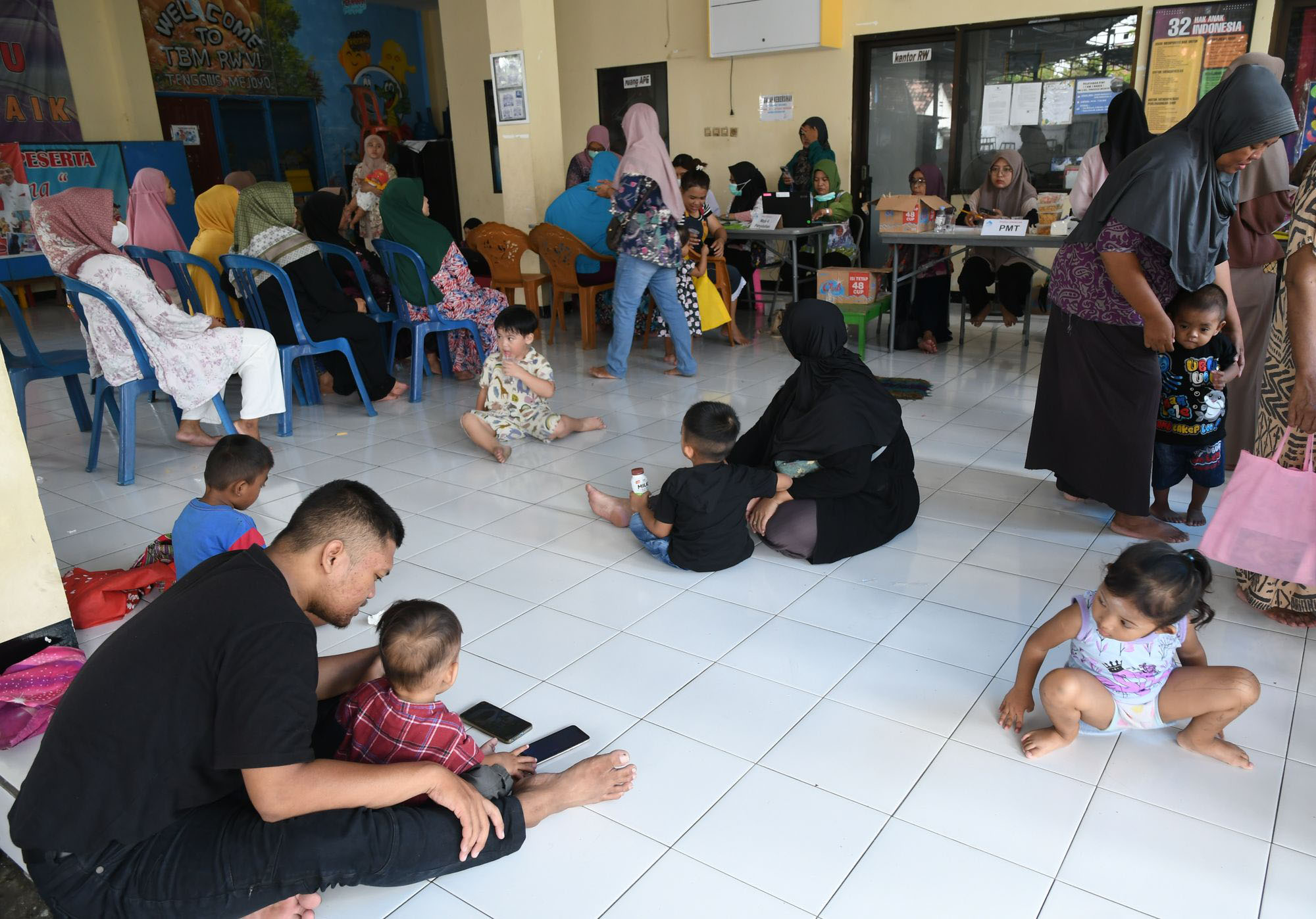 KESEHATAN WARGA - Setelah menjalani puasa selama satu bulan, warga dengan tertib mengikuti cek kesehatan warga dan balita secara gratis di Balai RW 06 Kel Tenggilis Mejoyo, Kec Tenggilis Mejoyo Surabaya, Kamis (10/4/2025).  Pemeriksaan oleh Puskesmas Tenggilis (pusat pelayanan keluarga) dengan Kader Surabaya Hebat (KSH) diantaranya cek gula darah dan asam urat serta mengukur tinggi dan berat badan serta imunisasi pada balita. (SURYA/HABIBUR ROHMAN)