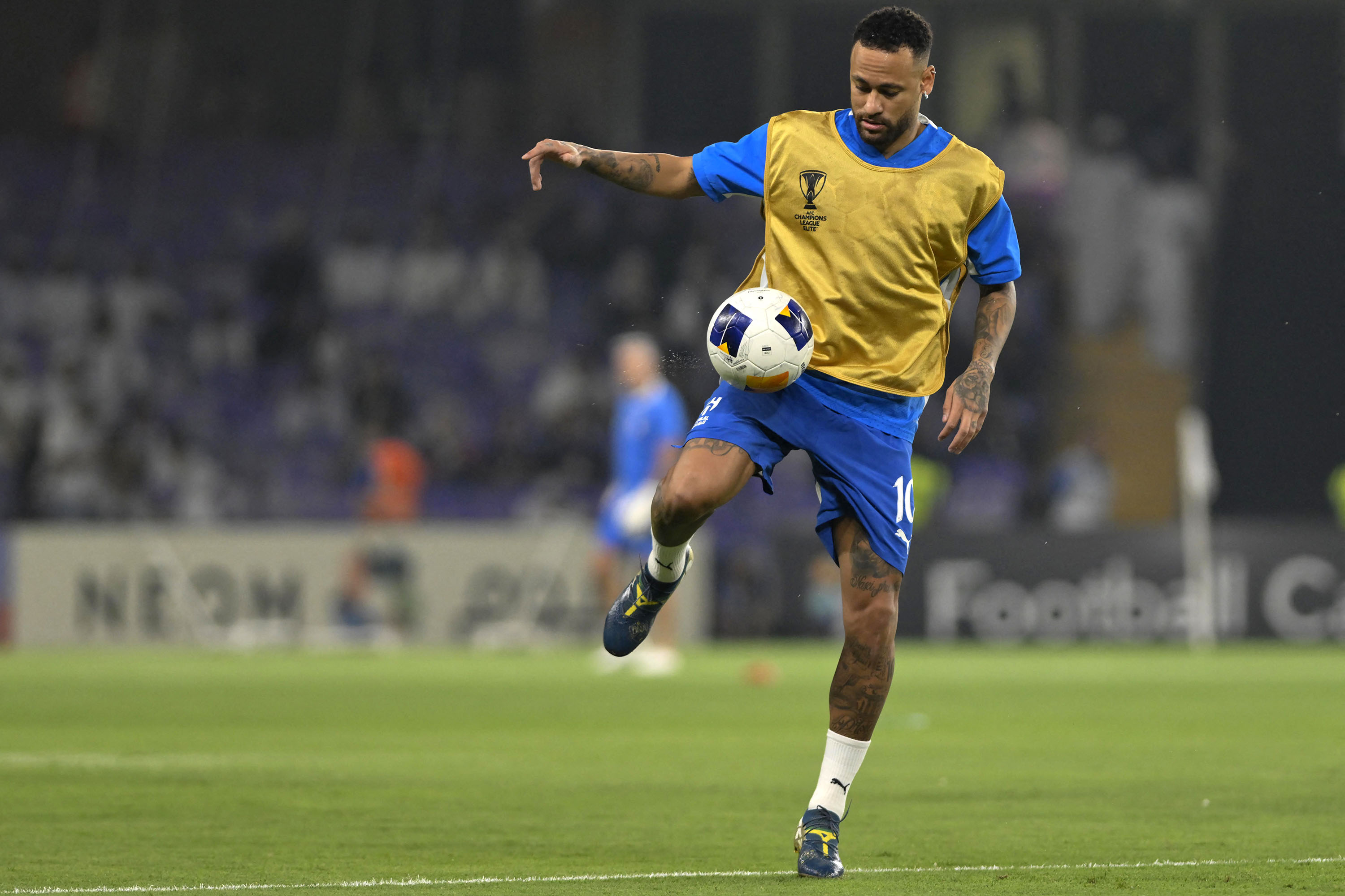 Pemain depan asal Brasil #10 Neymar melakukan pemanasan menjelang pertandingan sepak bola grup B Liga Champions AFC antara Al-Ain dari UEA dan Al-Hilal dari Saudi di Stadion Hazza bin Zayed di al-Ain pada 21 Oktober 2024. (Photo by Adel AL-NAIMI / AFP)