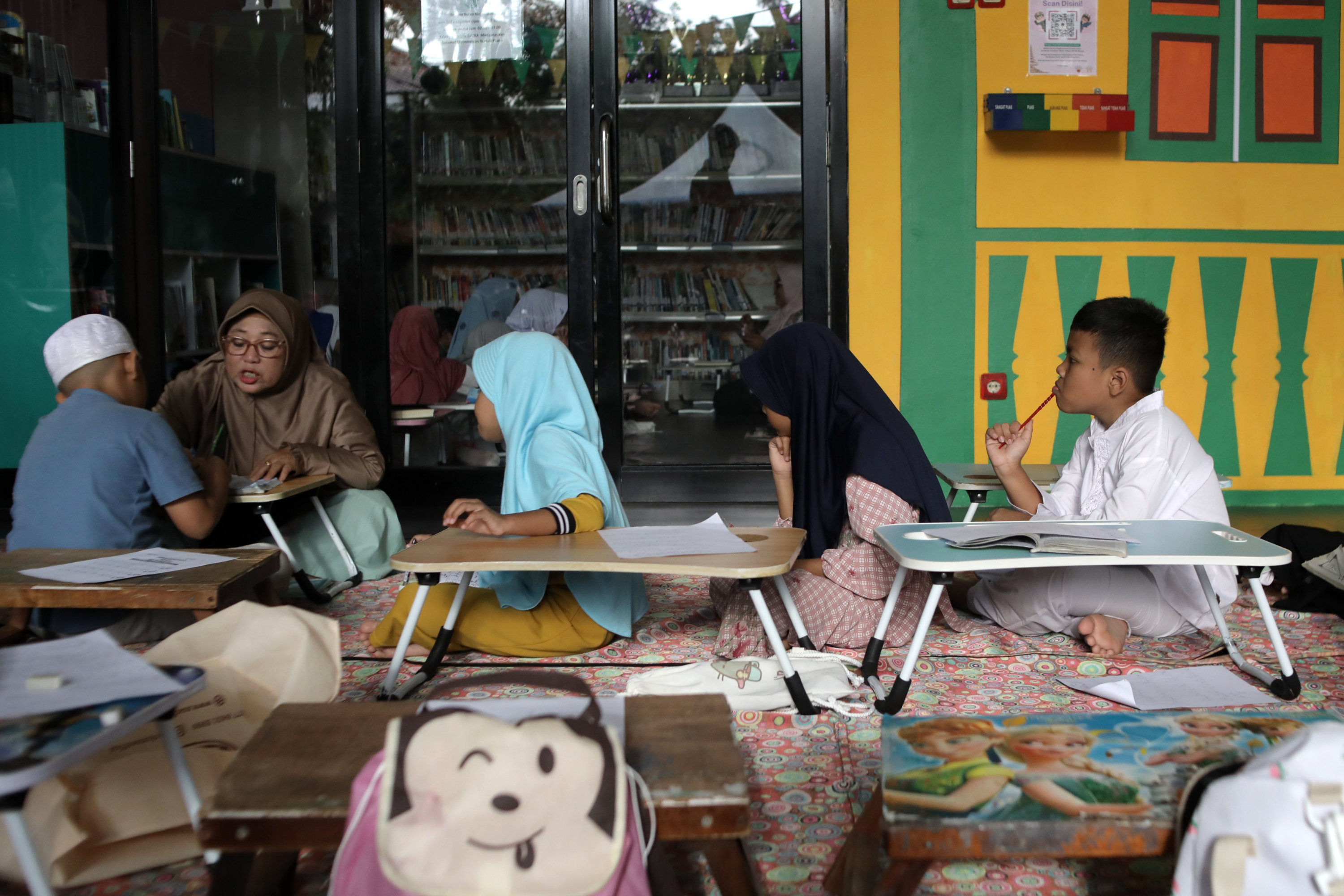 Sejumlah anak mengikuti kegiatan pesantren kilat Ramadan di RPTRA Malinjo, Jakarta, Minggu (1/3/2026). Kegiatan pesantren kilat yang dilaksanakan setiap bulan Ramadan tersebut diikuti puluhan peserta dari siswa jenjang TK-SD yang dibimbing oleh kelompok TP PKK Pejaten Barat untuk membekali ilmu agama anak usia dini, seperti belajar membaca Al-Quran dan Iqra, menghafal surat-surat pendek, menghafal doa-doa harian hingga edukasi tentang sejarah islam melalui dongeng dan film. TRIBUNNEWS/IRWAN RISMAWAN