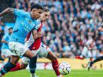 Aksi-Savinho-dan-Leandro-Trossard-pada-laga-Manchester-City-vs-Arsenal.jpg