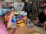 agen-brilink-arbaiyah-saat-melayani-nasabah-untuk-melakukan-setor-tunai-di-warung-kel.jpg