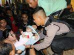 dea-bersama-bayinya-yang-masih-berumur-9-bulan-dibantu-oleh-aparat-kepolisian.jpg