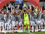 kiper-juventus-gianluigi-buffon-memegang-trofi-pemenang-saat-pemain-juventus-merayakan-kemenangan.jpg